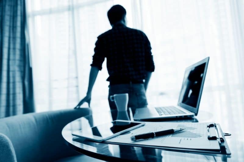 a man in his office looking out the window